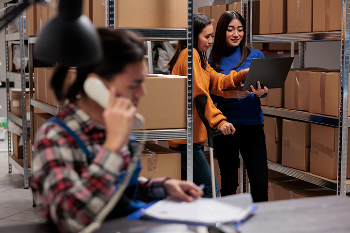 Women working with ERP technology in warehouse